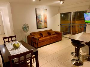 sala de estar con sofá y mesa en Apart Mejillones - Dpto 22 en Mejillones