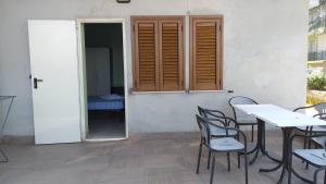 a table and chairs in front of a building at Room in BB - Spacious double room a stones throw from the sea in Pineto