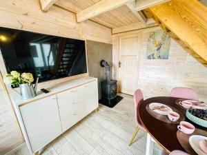 a dining room with a table and a stove at Magic Home Łeba in Łeba