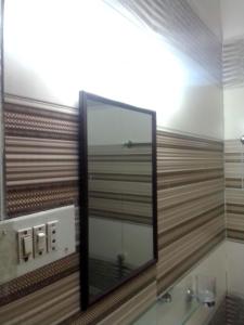 a bathroom with a mirror and a sink at Newly Renovated GuestHouse in Islamabad