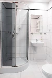 a bathroom with a shower and a toilet and a sink at Senator in Katowice