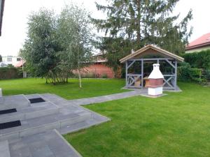 a garden with a gazebo in the grass at Cicha 3 in Sztutowo