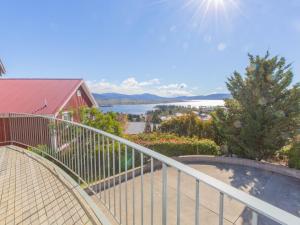 a balcony with a railing and a view of the water at Chalet De Neige 2 9 Jillamatong Street in Jindabyne