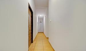a hallway with a white door and a tile floor at Itsy Hotels Vailankanni Natures Inn in Panaji