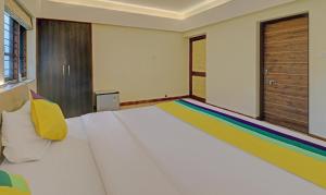 Postel nebo postele na pokoji v ubytování Itsy Hotels Vailankanni Natures Inn