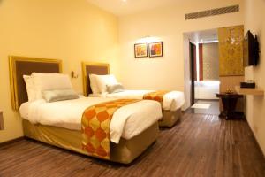 Postel nebo postele na pokoji v ubytování Hotel Sabareesh Park