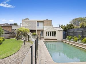 a house with a swimming pool in front of it at Blue Horizon Mt Eliza in Mount Eliza