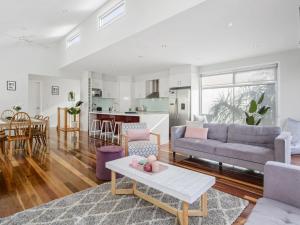 a living room with a couch and a table at Trinity Beach House in Rosebud