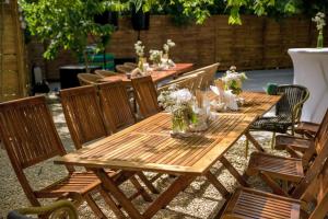 a wooden table and chairs with flowers on it at Annador in Jupiter