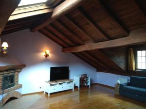 a living room with a tv and a fireplace at Casa Serafo in Saliencia