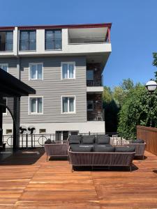 a building with a deck with couches and a building at Istanbul Park Hotel in Tuzla