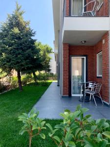 a patio with a table and chairs next to a building at Istanbul Park Hotel in Tuzla