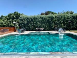 a swimming pool with tables and chairs in a yard at Istanbul Park Hotel in Tuzla