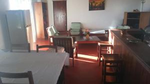 a kitchen and dining room with a table and chairs at Maison du Bonheur in Sainte Marie