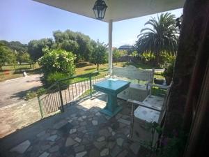 a blue table on the balcony of a house at GARDEN ROOMS in Castro-Urdiales
