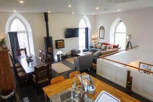 a kitchen and a living room with a couch at Old Chapel in St Just