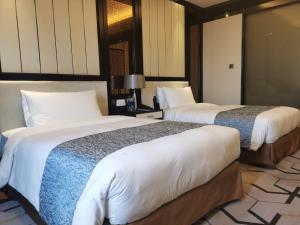 Voodi või voodid majutusasutuse PRIMUS Hotel Wuhan Hannan toas