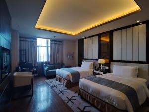 Voodi või voodid majutusasutuse PRIMUS Hotel Wuhan Hannan toas