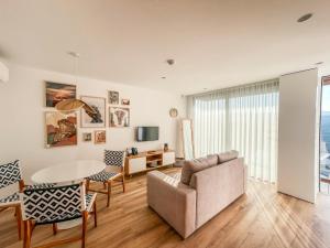 a living room with a couch and a table at Encosta de Louredo by Pousadela Village in Vieira do Minho