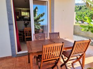 a wooden dining table and chairs in a room at Arco da Calheta Villa in Arco da Calheta