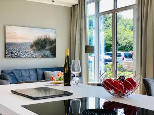 ein Wohnzimmer mit einem Tisch und einer Flasche Wein in der Unterkunft Strandvilla Charlotte Binz in Binz
