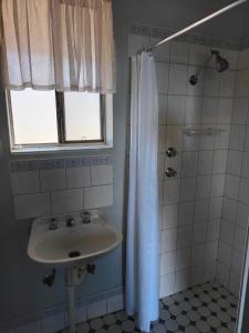 a bathroom with a sink and a shower at Airport Whyalla Motel in Whyalla