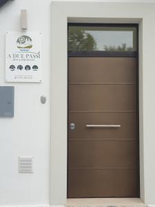 a door to a garage with a sign on it at A DUE PASSI BED & BREAKFAST in Troia