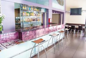 a bar in a restaurant with bar stools at Reino de Granada in Granada