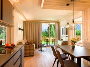 a kitchen and living room with a table and chairs at Alpin Apartments in Mayrhofen