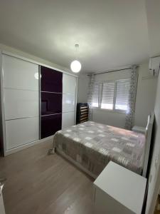a bedroom with a bed and a large window at Appartamento Saranda in Sarandë +7 photos