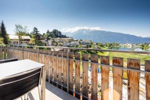 a balcony with a view of a lake and mountains at COCOON - Laax in Laax