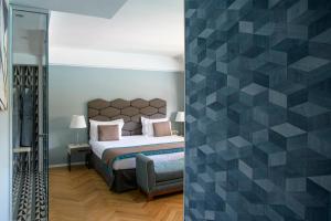 a bedroom with a bed and a glass wall at Grand Hotel Portovenere in Portovenere
