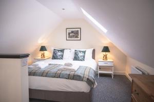 Poachers Cottage في ليبرن: غرفة نوم بسرير وليلتين