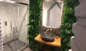 a bathroom with a sink and a mirror at Casa Eden - Mountain View, Infinity Pool in Málaga