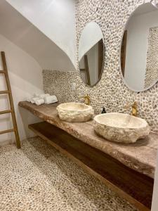 two sinks in a bathroom with two mirrors at Preabeach Boutique Hotel & SPA in Prea