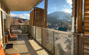 a balcony with a view of a mountain at Apartmány Čertovka in Harrachov