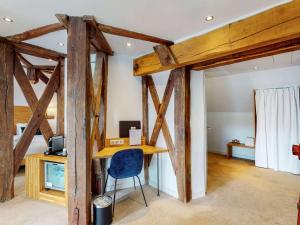a desk in a room with wooden beams at Mercure Poitiers Centre in Poitiers