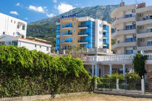 a view of a building with a mountain in the background at Atlantic sobe in Dobra Voda