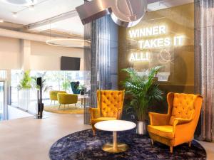 a waiting room with two chairs and a table at IBIS Styles Kaunas Centre in Kaunas