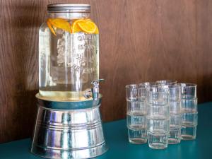 a blender with glasses of water on a table at IBIS Styles Kaunas Centre in Kaunas