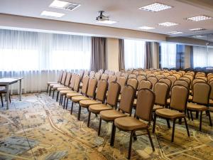 a room with rows of chairs and a table at IBIS Styles Kaunas Centre in Kaunas
