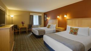 a hotel room with two beds and a flat screen tv at Best Western Acadia Park Inn in Bar Harbor