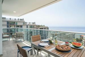 a balcony with a table with a pizza on it at Alameda Formosa I by An Island Apart in Funchal