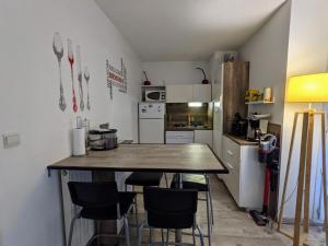 a kitchen with a table and chairs in a room at F2 garage box WiFi terasse clim Gare Fac Eco Richter in Montpellier