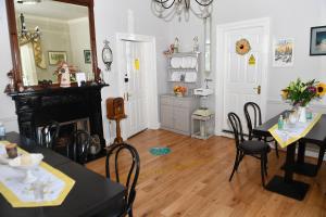 a dining room with tables and chairs and a mirror at Railway House Guest House in Mullingar