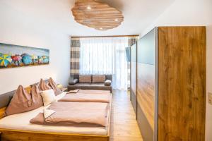 a living room with a bed and a couch at Achen Appartement in Bad Hofgastein