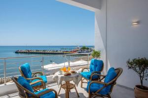 a balcony with a table and chairs and the ocean at Amazing Seafront Suite in Ierápetra