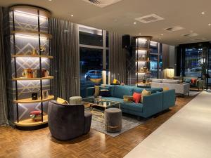 a living room with a blue couch and chairs at Postboutique Hotel Wuppertal in Wuppertal