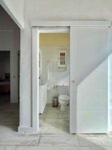 a white bathroom with a toilet and a sink at La Casita de la Parra, El Hierro in Tamaduste +20 photos