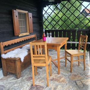 a wooden table and two chairs and a table and a bench at Kranach 5 - Wohnen beim Wein in Gamlitz